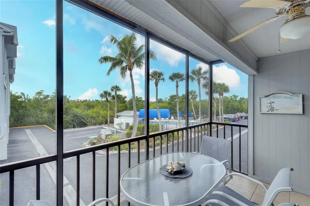 a view of a city from a dining room with furniture wooden floor and a floor to ceiling window