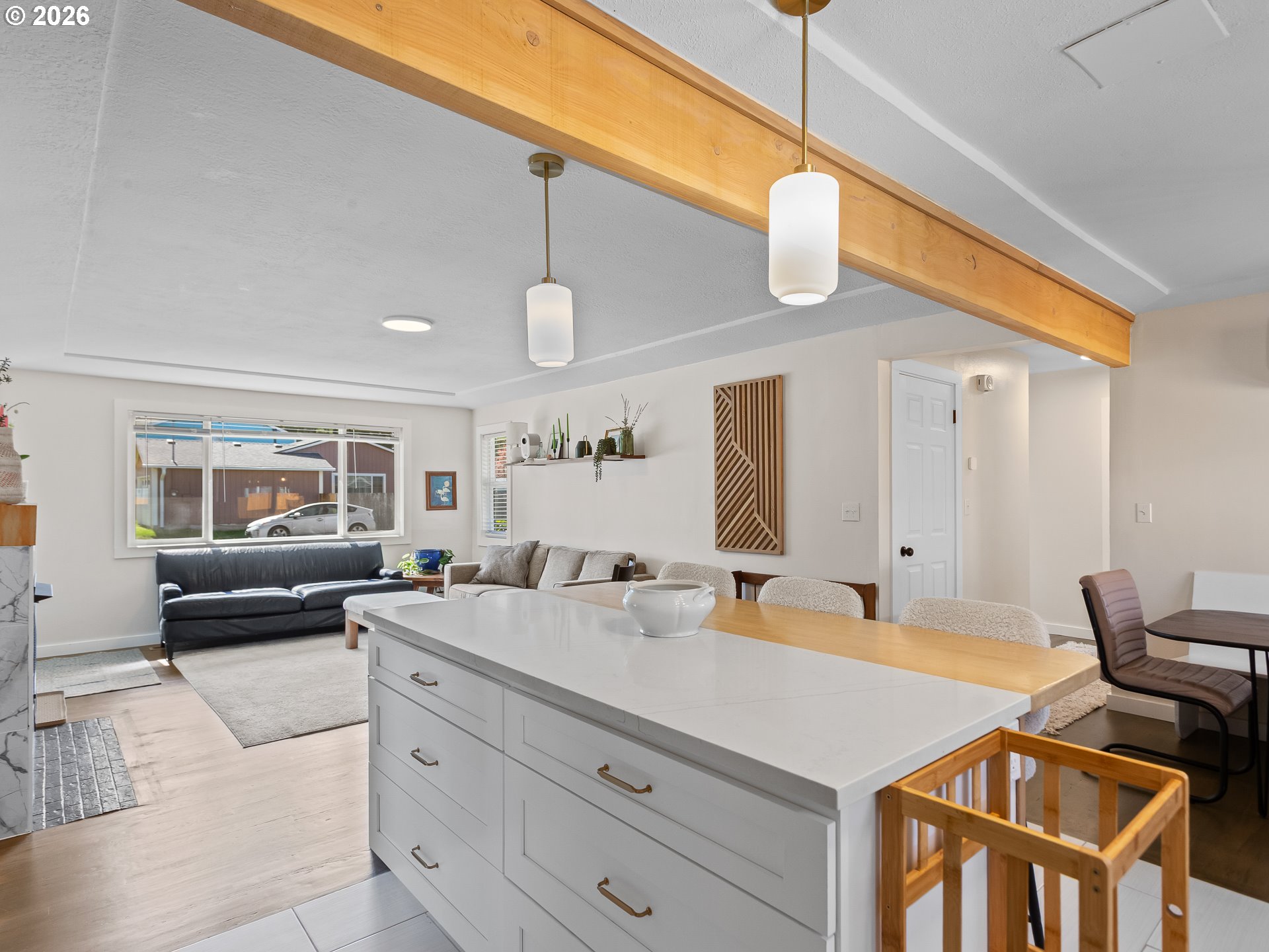 20149 Northeast Oregon Street Fairview, OR 97024 - Photo 12 of 37 a large white kitchen with a stove a sink dishwasher a dining table and chair with wooden floor
