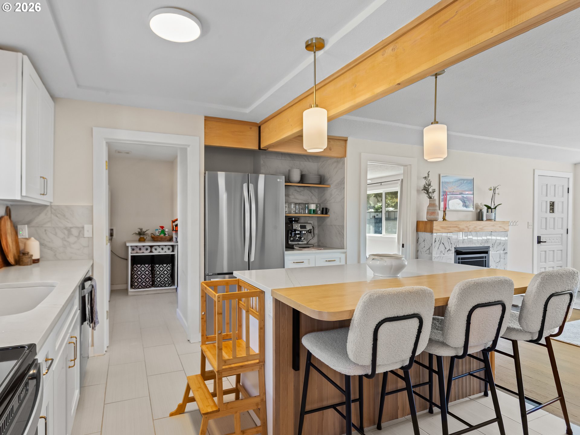 20149 Northeast Oregon Street Fairview, OR 97024 - Photo 16 of 37 a kitchen with a table chairs microwave and refrigerator