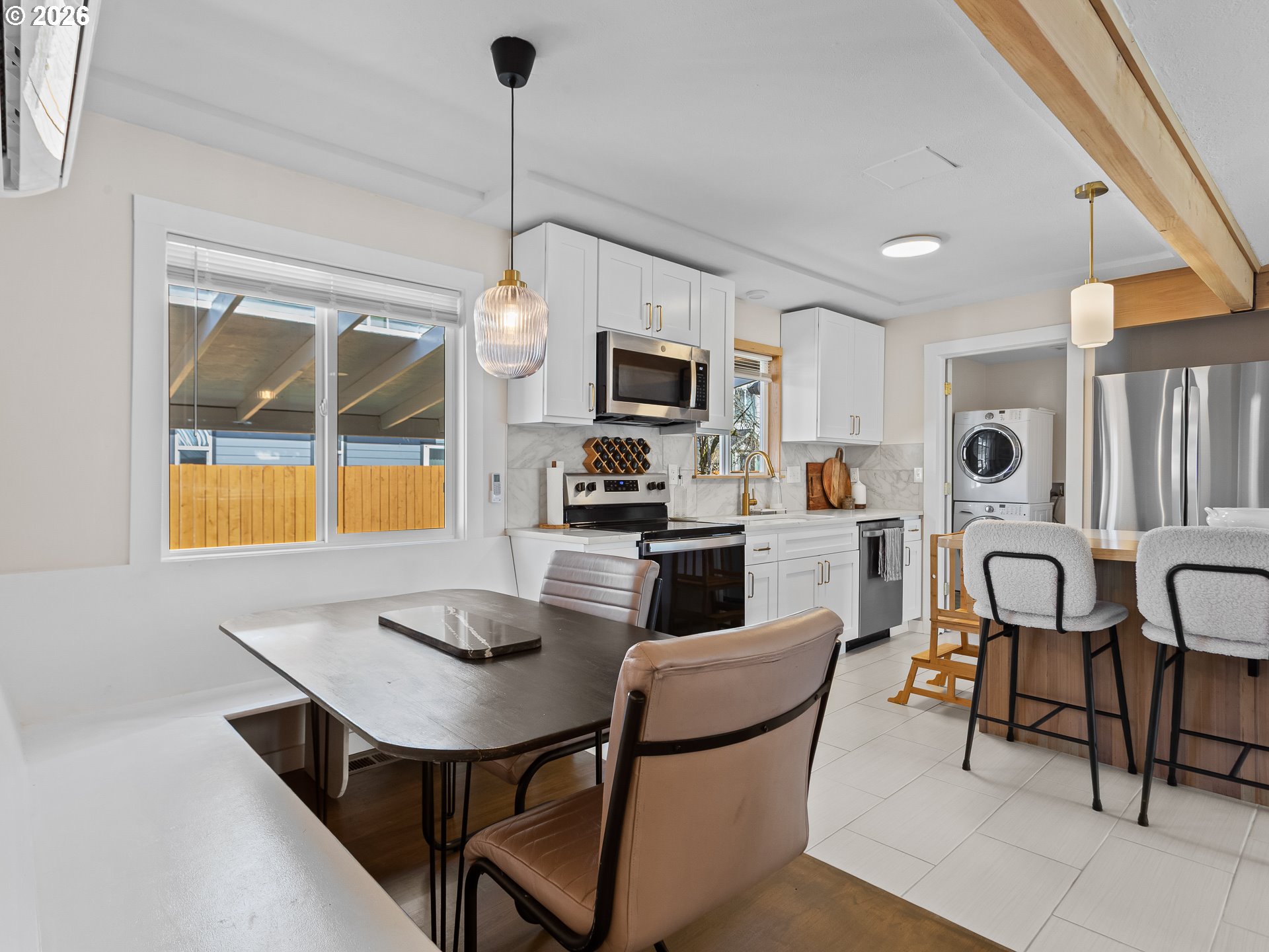 20149 Northeast Oregon Street Fairview, OR 97024 - Photo 18 of 37 a kitchen with a dining table chairs and white cabinets