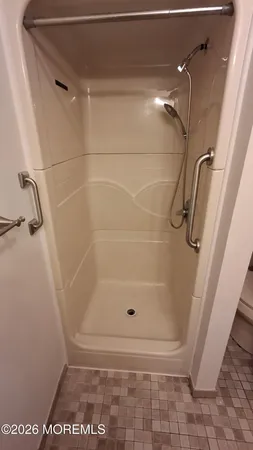 a bathroom with a glass shower door