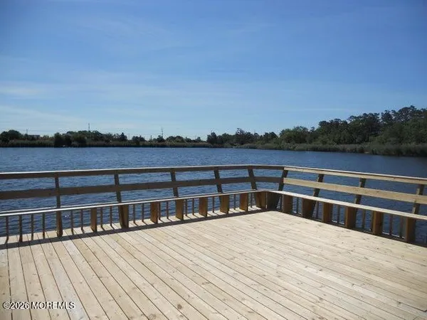 a view of balcony with wooden floor and fence