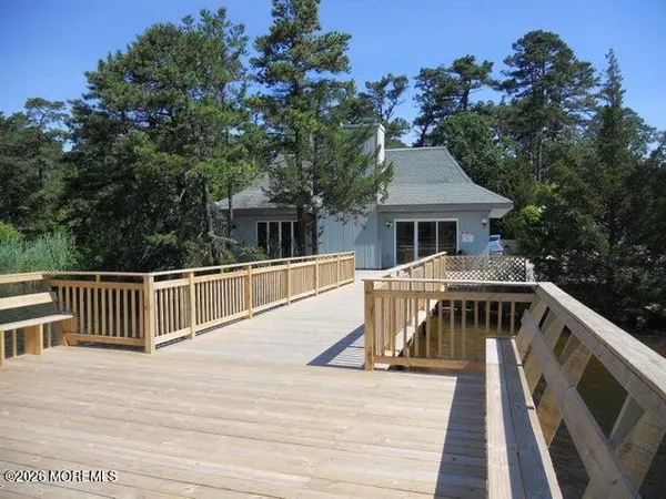 a view of a house with wooden deck