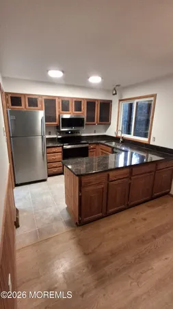 a kitchen with stainless steel appliances granite countertop a stove a refrigerator and a sink