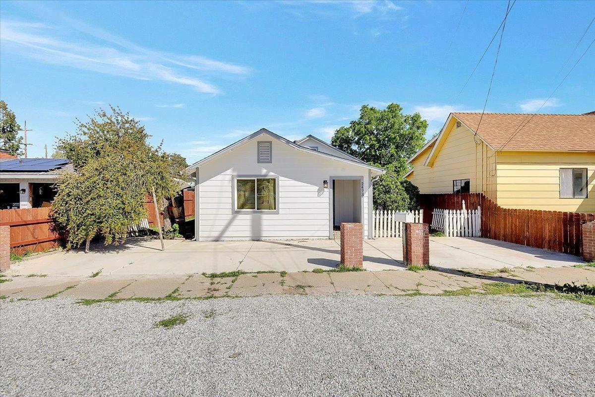 2473 Date Street Live Oak, CA 95953 - Photo 1 of 27 a front view of a house with a yard and garage