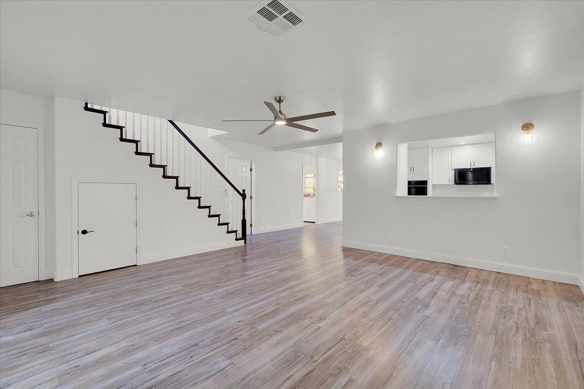 2473 Date Street Live Oak, CA 95953 - Photo 16 of 27 a view of an empty room with wooden floor and a ceiling fan