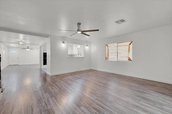 wooden floor in an empty room with a window