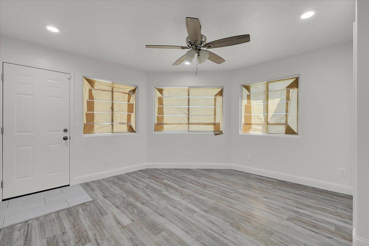 2473 Date Street Live Oak, CA 95953 - Photo 18 of 27 an empty room with wooden floor windows and fan