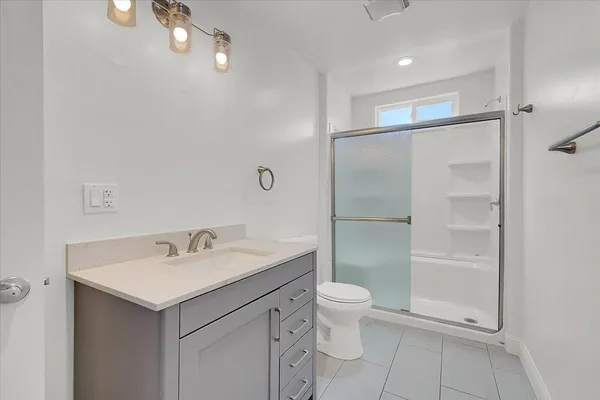 a bathroom with a sink toilet and shower
