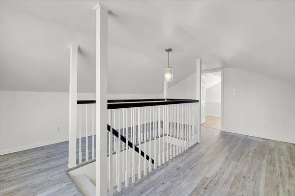 a view of an entryway with wooden floor