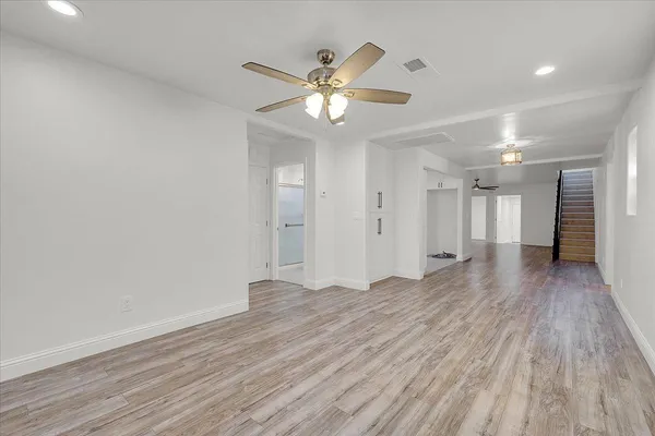 a view of an empty room with a ceiling fan