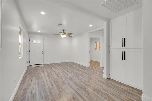 a view of an empty room with wooden floor