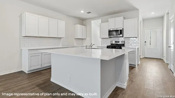 a kitchen with a sink a stove and cabinets