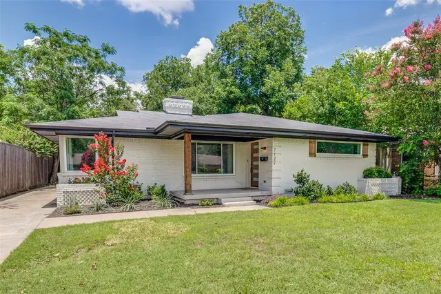 a front view of house with yard and outdoor seating