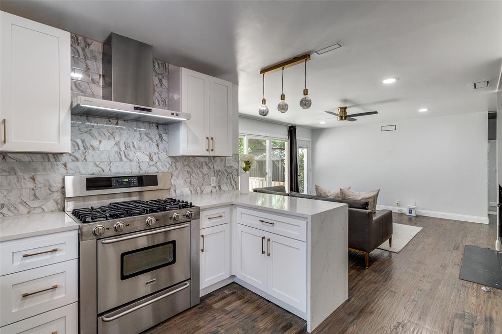 7127 East Mockingbird Lane Dallas, TX 75214 - Photo 11 of 31 a kitchen with cabinets appliances and a wooden floor