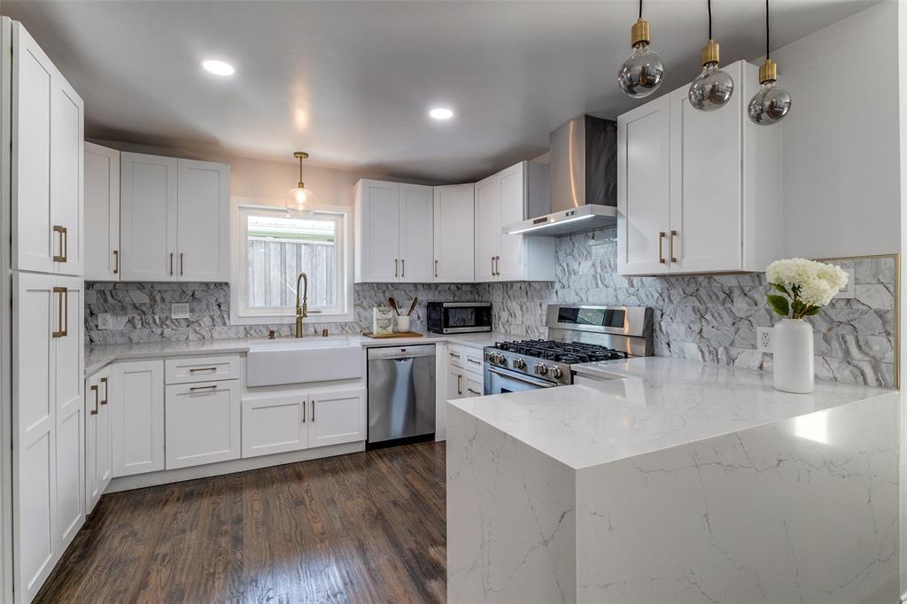 7127 East Mockingbird Lane Dallas, TX 75214 - Photo 13 of 31 a kitchen with a stove cabinets and wooden floor