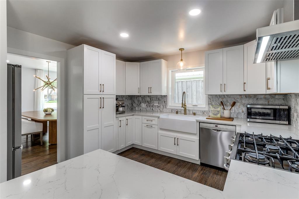 7127 East Mockingbird Lane Dallas, TX 75214 - Photo 14 of 31 a kitchen with white cabinets and appliances