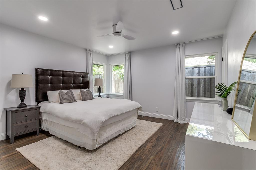 7127 East Mockingbird Lane Dallas, TX 75214 - Photo 15 of 31 a large bedroom with a bed and wooden floor