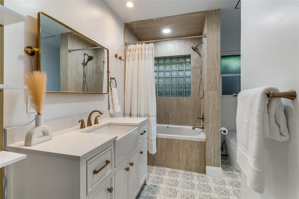 7127 East Mockingbird Lane Dallas, TX 75214 - Photo 20 of 31 a bathroom with a sink a toilet and shower