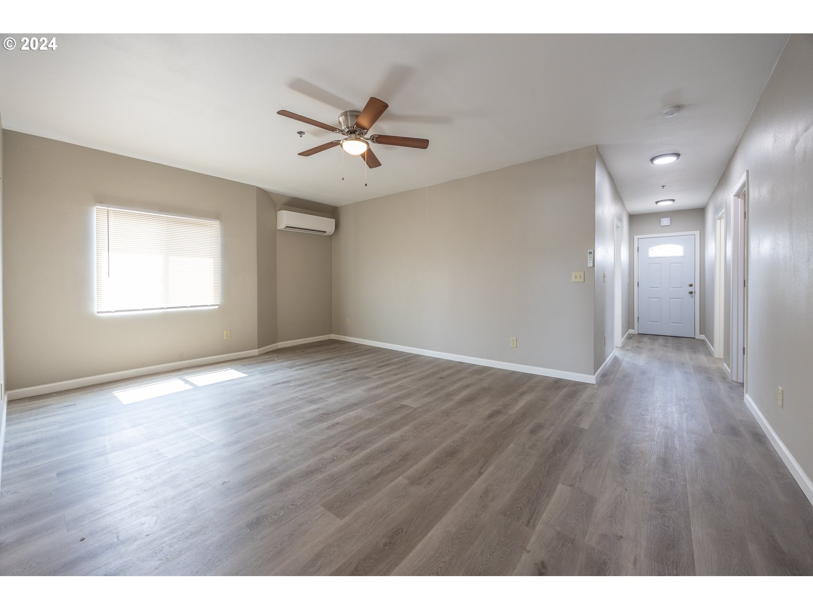 415 Southwest 7th Street Pendleton, OR 97801 - Photo 11 of 44 a view of an empty room with wooden floor and a window