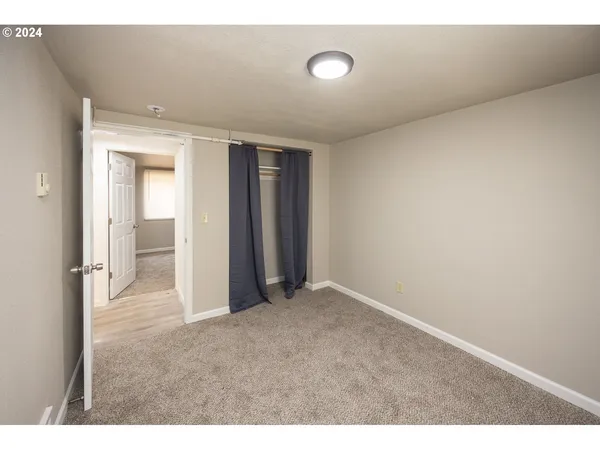 a view of an empty room and closet