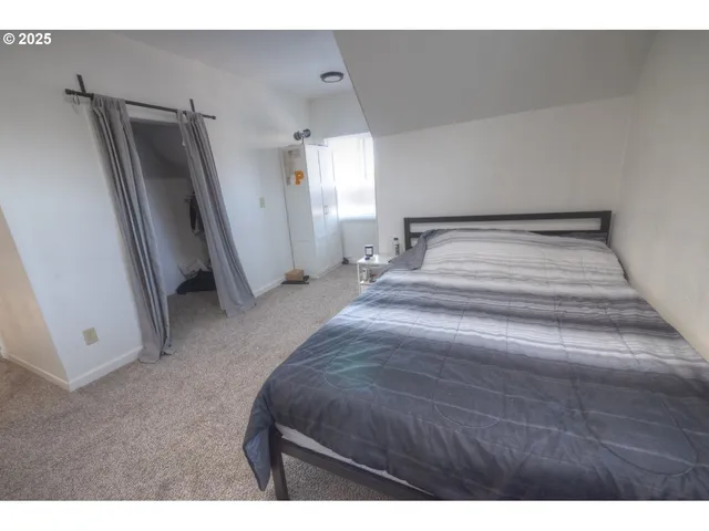 a bedroom with a bed and a large mirror