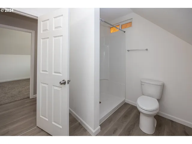 a bathroom with a toilet and a shower