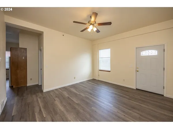 a view of an empty room and wooden floor