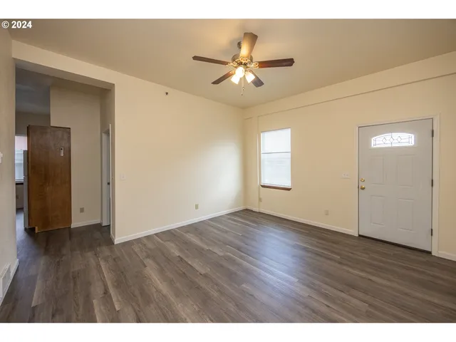 a view of an empty room and wooden floor