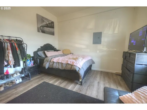 a bedroom with a bed and a flat screen tv