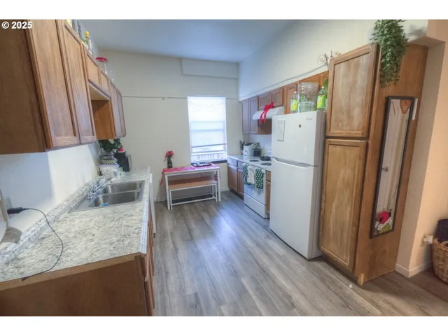 a kitchen with a refrigerator and a sink