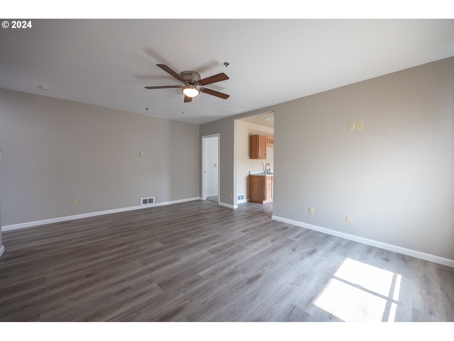 415 Southwest 7th Street Pendleton, OR 97801 - Photo 6 of 44 a view of an empty room with wooden floor and a window