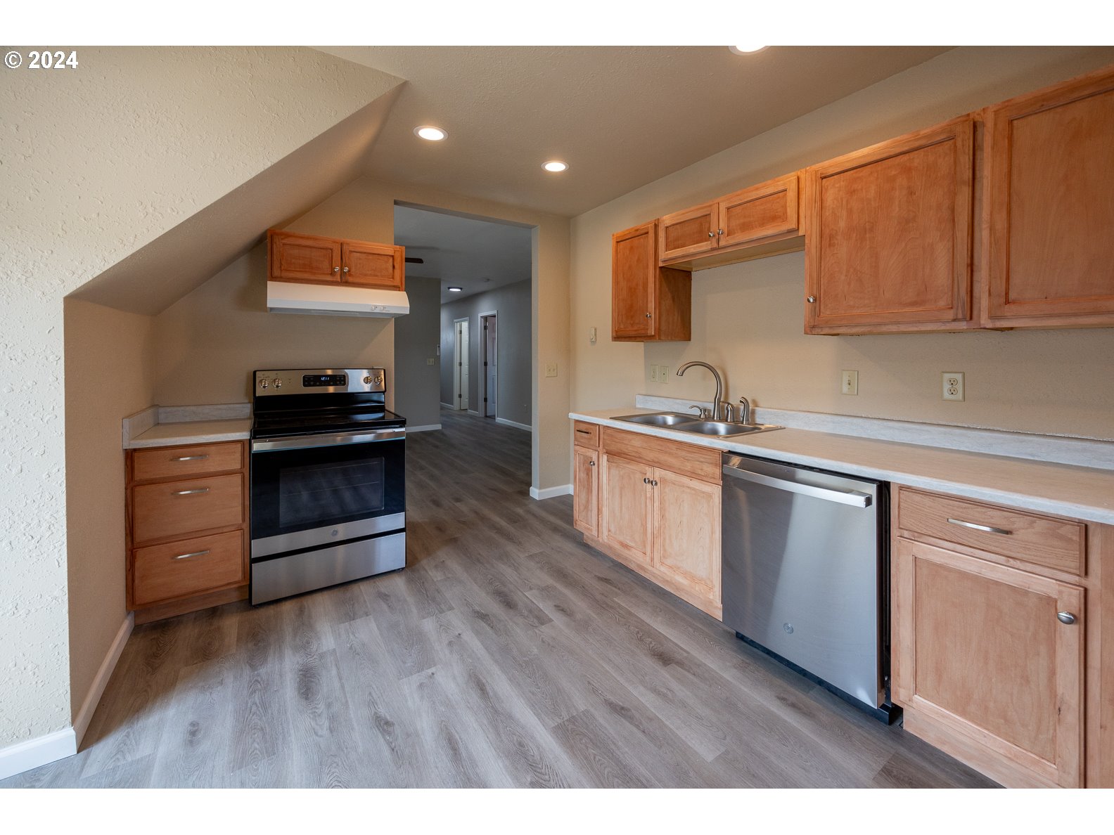 415 Southwest 7th Street Pendleton, OR 97801 - Photo 9 of 44 a kitchen with stainless steel appliances granite countertop a sink and cabinets