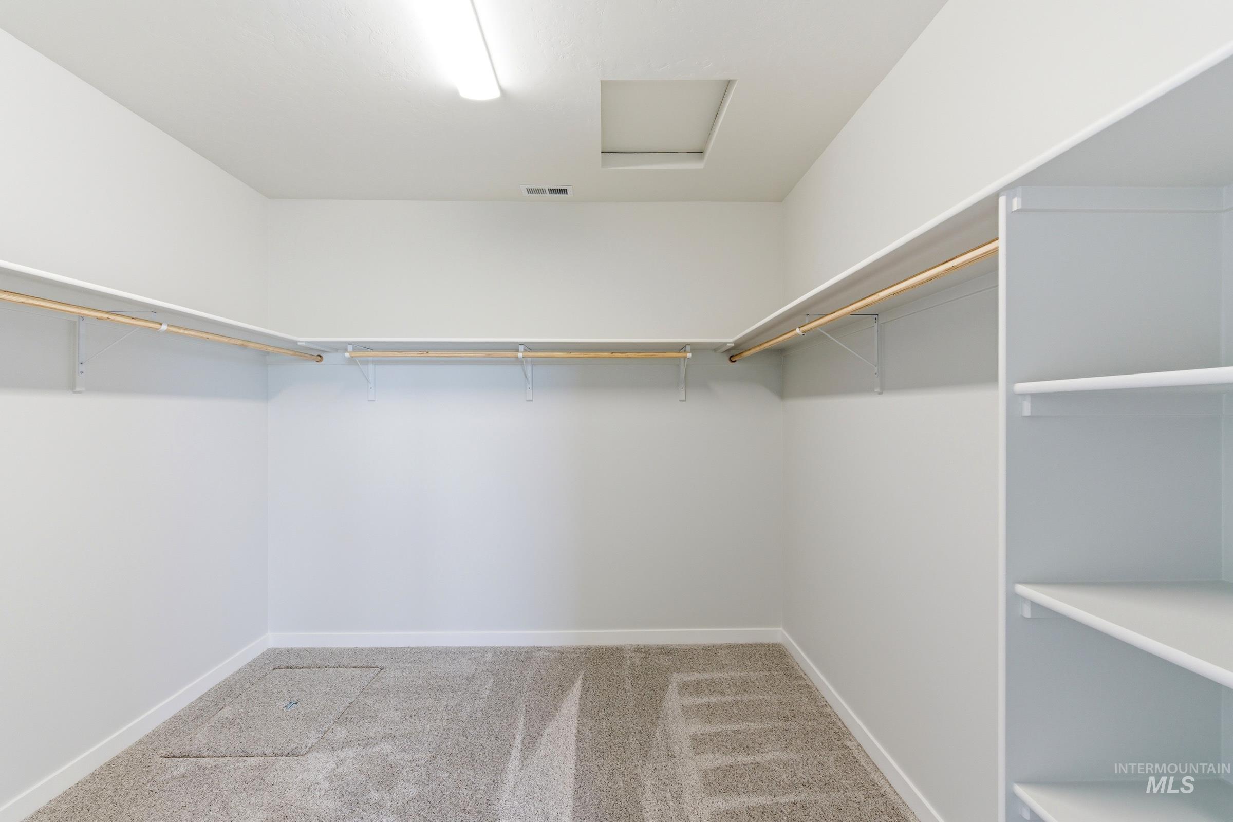 13663 Redway Court Caldwell, ID 83607 - Photo 29 of 32 Expansive walk-in closet featuring light-toned carpeting, white walls, and built-in shelving