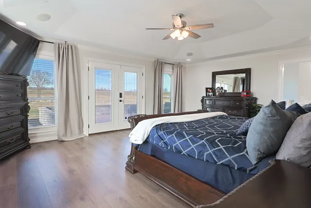 a bedroom with a bed and a chandelier