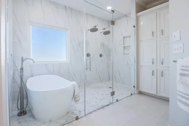 a bathroom with a bathtub and a shower