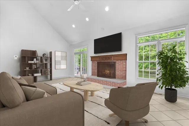 a living room with furniture a flat screen tv and a fireplace