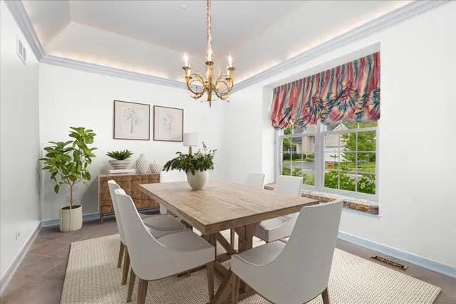 a view of a dining room with furniture a chandelier and wooden floor