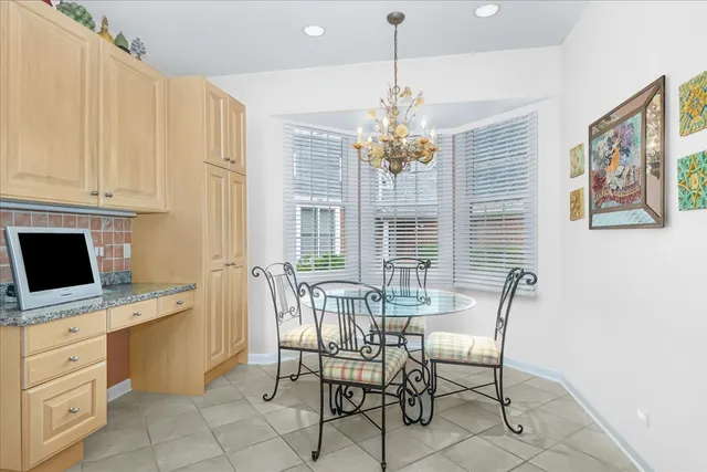a view of a dining room with furniture and chandelier