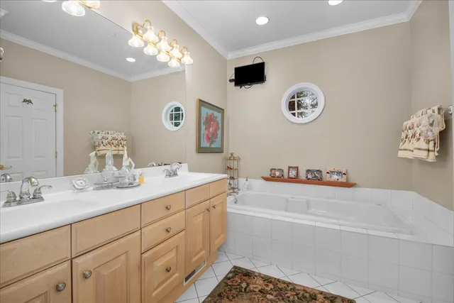 a bathroom with a tub sink and a mirror
