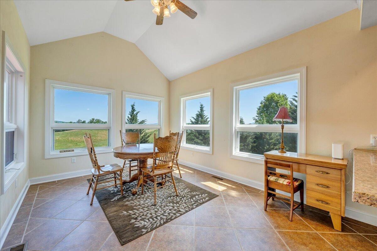 625 Frontier Way Fincastle, VA 24090 - Photo 26 of 105 a living room with furniture a large window and a dining table