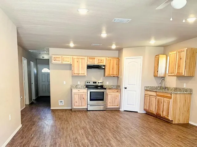 a kitchen with stainless steel appliances granite countertop a stove and a refrigerator