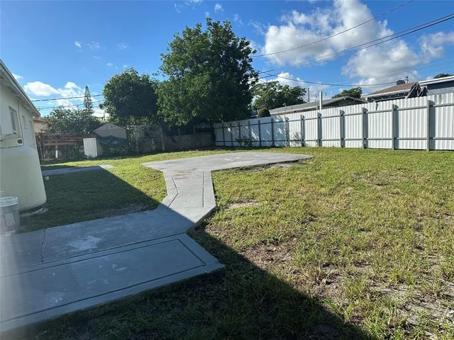 a view of a swimming pool with a yard
