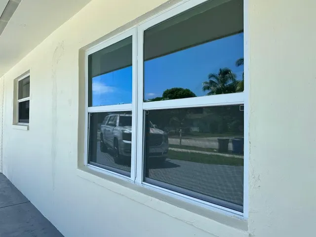a bathroom with a glass door and a window