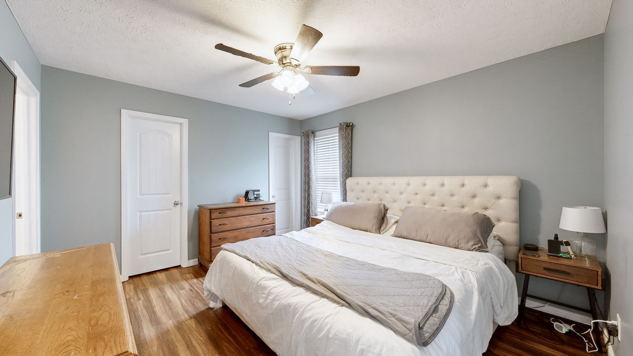 1462 East Ab Wade Road Portland, TN 37148 - Photo 17 of 52 a bedroom with a bed and a chandelier