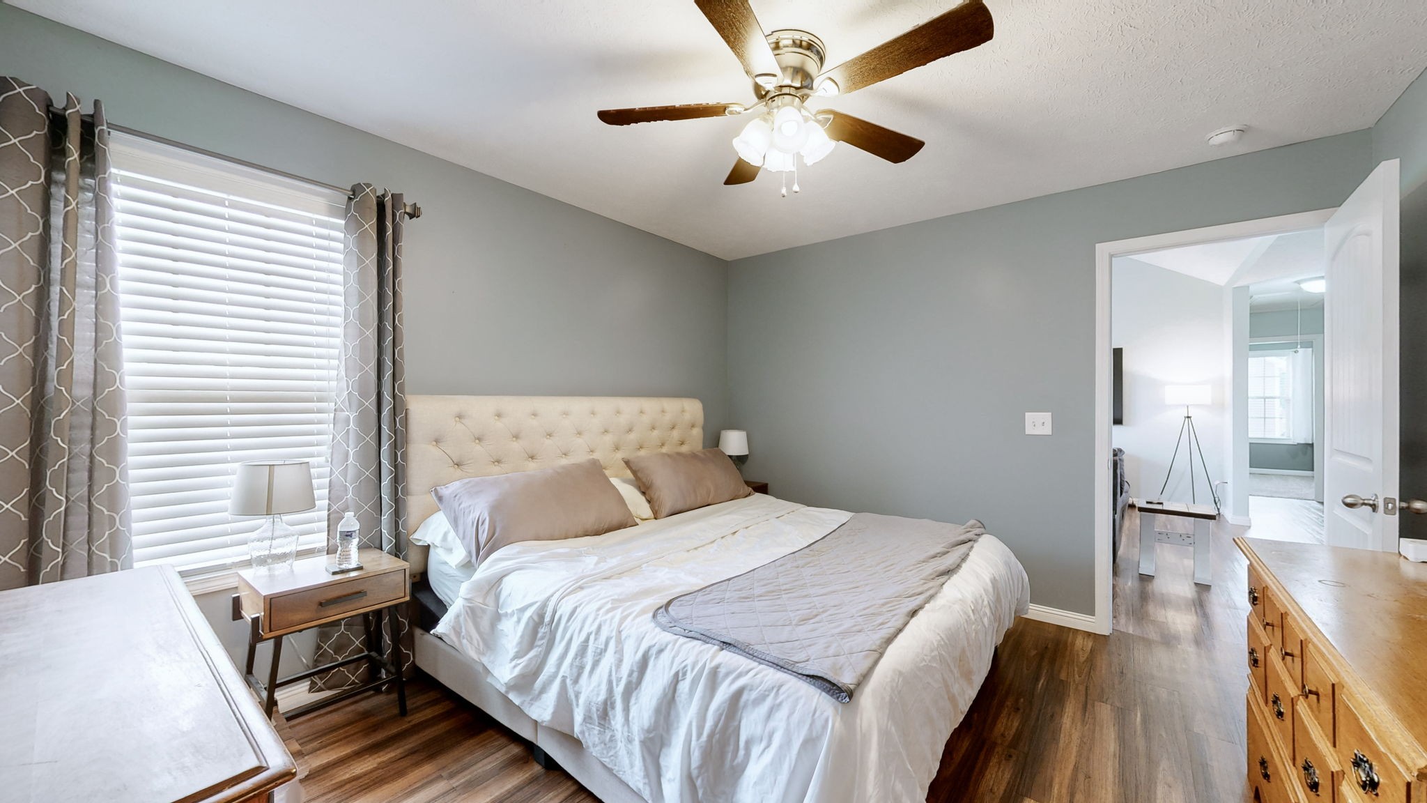 1462 East Ab Wade Road Portland, TN 37148 - Photo 18 of 52 a bedroom with a large bed and a chandelier