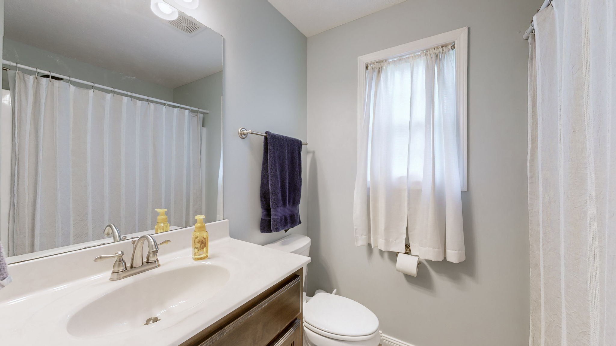 1462 East Ab Wade Road Portland, TN 37148 - Photo 25 of 52 a bathroom with a sink a toilet and mirror
