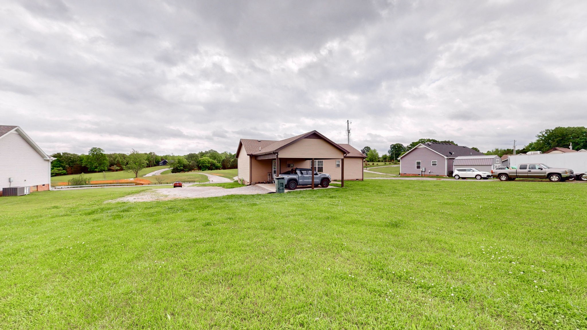 1462 East Ab Wade Road Portland, TN 37148 - Photo 32 of 52 a view of a house with a big yard plants and large trees