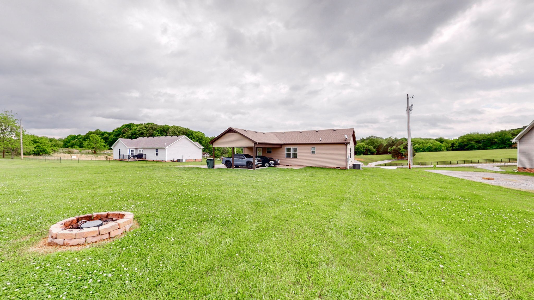 1462 East Ab Wade Road Portland, TN 37148 - Photo 34 of 52 a view of a house with a big yard and a garden