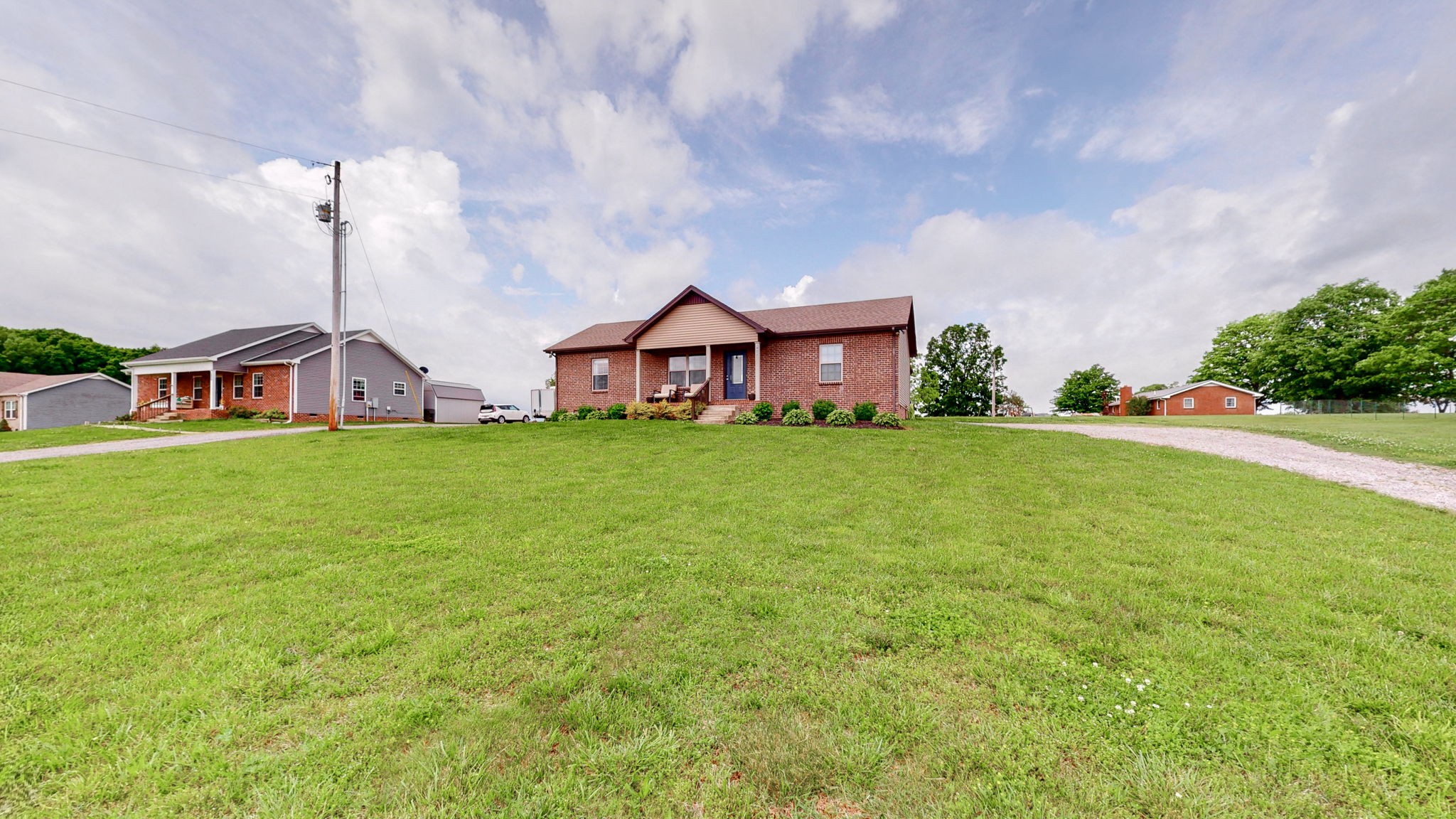 1462 East Ab Wade Road Portland, TN 37148 - Photo 41 of 52 a view of a house with a big yard and large trees